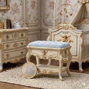 May include: A miniature nursery set with a crib, dresser, and bench. The furniture is cream-colored with gold accents and blue details. The bench has a light blue cushion. A one Euro coin is in the foreground.
