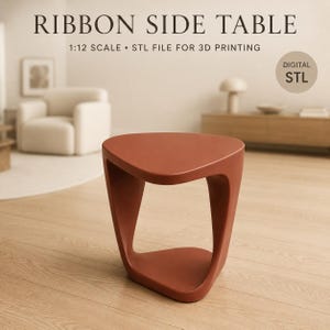 May include: A terracotta-colored side table with a curved, ribbon-like structure and a triangular top. The text reads: RIBBON SIDE TABLE, 1:12 SCALE • STL FILE FOR 3D PRINTING, and DIGITAL STL. This is a digital file for 3D printing purposes.