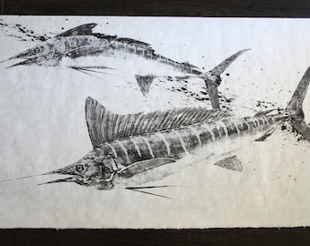 May include: Black and white ink drawing of two marlin fish on a white background. The fish are depicted in a dynamic pose, with their tails and fins spread out. The drawing is done in a realistic style, with detailed markings on the fish's bodies.