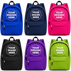 May include: Six backpacks in blue, navy, pink, black, purple, and lime green. Each bag features a top handle, adjustable shoulder straps, a front zippered pocket, and a circular white graphic on the front with the text YOUR DESIGN HERE or YOUR IMAGE HERE.