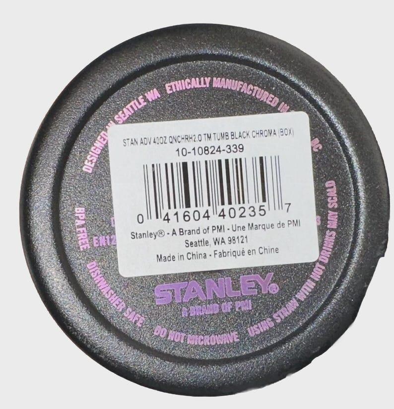 May include: Black tumbler base with a white label and barcode. The label includes the text "STAN ADV 400Z QNCHRH2.0 TM TUMB BLACK CHROMA (BOX)" and "STANLEY A BRAND OF PMI". The base is marked "Dishwasher Safe" and "Do Not Microwave".