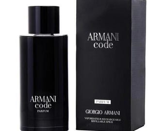 May include: A black cylindrical perfume bottle with a matching cap and the text Armani Code Parfum printed in silver. Beside it stands a rectangular black cardboard box featuring the text Armani Code, Parfum, and Giorgio Armani Vaporisateur Rechargeable.