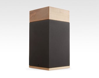 May include: A black wooden box with a light brown wood top. The box is made by Memento Memorials.