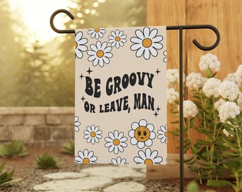 May include: A beige garden flag with a white daisy pattern and the text "BE GROOVY OR LEAVE, MAN".