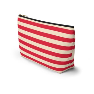 Red and cream striped bag with the words "Oh Shit Kit" used for storing medicine and supplies.
