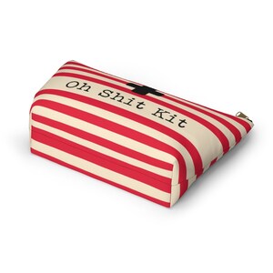 Red and cream striped bag with the words "Oh Shit Kit" used for storing medicine and supplies.