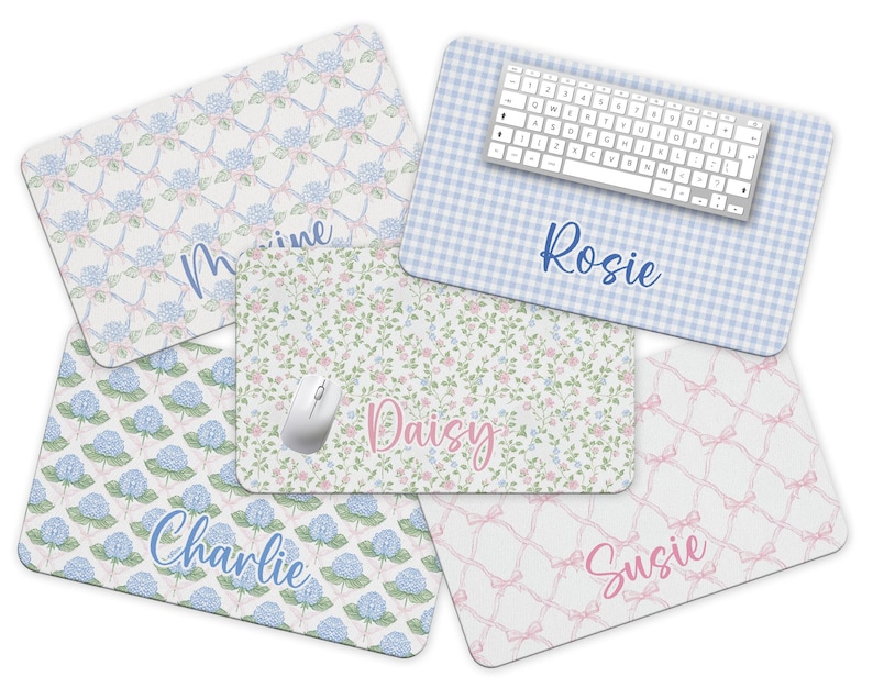 May include: Set of six personalised mouse mats with different floral patterns and names. The mouse mats feature a blue and white gingham pattern, a floral pattern with pink and blue flowers, a blue and white hydrangea pattern, a pink and white bow pattern, and a floral pattern with pink and white flowers. The names on the mouse mats are Rosie, Daisy, Charlie, Susie, and Marine.