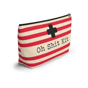 Red and cream striped bag with the words "Oh Shit Kit" used for storing medicine and supplies.