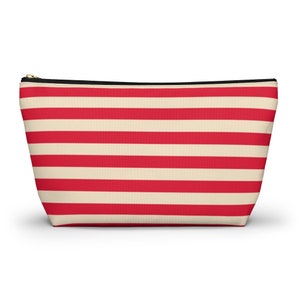 Red and cream striped bag with the words "Oh Shit Kit" used for storing medicine and supplies.