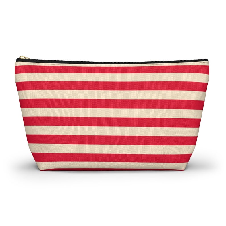 Red and cream striped bag with the words "Oh Shit Kit" used for storing medicine and supplies.