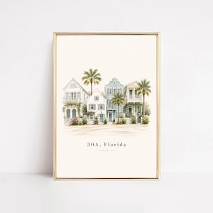 May include: A framed art print featuring a watercolor illustration of coastal houses in soft blue and white tones, surrounded by palm trees and greenery. The text 30A, Florida is printed in black at the bottom center of the off-white background.