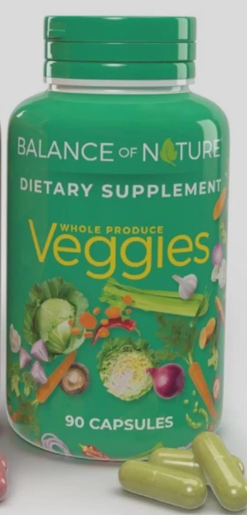 May include: A green bottle of dietary supplement capsules labeled "Balance of Nature." The bottle features the word "Veggies" with illustrations of vegetables. The bottle contains 90 capsules.
