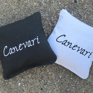 Custom Cornhole Game Bags with a Last Name - Set of 8 Shown in Black and White