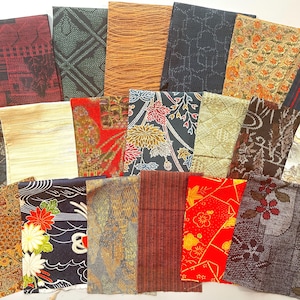 May include: A collection of rectangular fabric swatches featuring diverse patterns including floral motifs, geometric shapes, and abstract lines in colours such as red, black, gold, green, and brown, arranged in an overlapping grid layout.