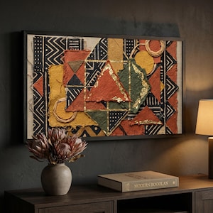 May include: A framed abstract artwork with geometric shapes in red, yellow, green, and black. The artwork features triangles, squares, and circles with gold leaf accents. The frame is dark brown, and the artwork is displayed above a wooden cabinet.