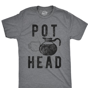May include: A gray t-shirt with a black graphic of a coffee pot and a coffee cup with the text "POT HEAD" printed on it.