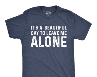 May include: A dark blue t-shirt with a white distressed graphic that reads "It's a beautiful day to leave me alone."