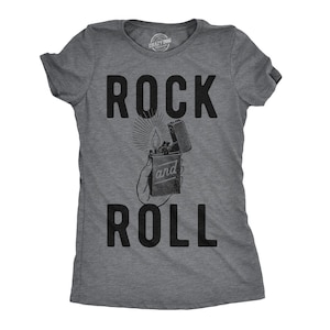 May include: Gray t-shirt with the text "Rock and Roll" in black. A black and white illustration of a lighter with a flame is between the words.