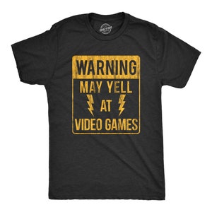 May include: A black t-shirt with a yellow warning sign that reads "WARNING MAY YELL AT VIDEO GAMES".