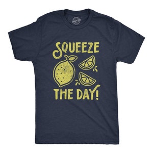 May include: A navy blue t-shirt with a yellow lemon graphic and the text "Squeeze the Day!"