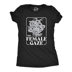 May include: Black t-shirt with a white graphic of a woman's face with snakes for hair. The text "THE FEMALE GAZE" is below the image.