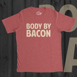 May include: Red heather t-shirt with the text "BODY BY BACON" in white.