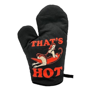 May include: Black oven mitt with a red chili pepper and a woman on it. The text "THAT'S HOT" is printed on the mitt.
