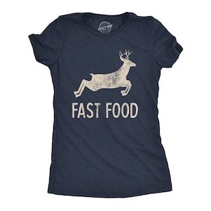 May include: Navy blue t-shirt with a distressed graphic of a leaping deer and the words "FAST FOOD" in a bold, sans-serif font. The shirt has short sleeves and a crew neck.