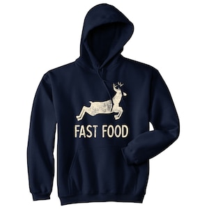 May include: A navy blue hooded sweatshirt with a white silhouette of a deer running and the text "FAST FOOD" printed on the front.