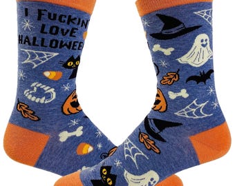 May include: A pair of blue crew socks with orange cuffs, heels, and toes. The socks feature a Halloween pattern including black cats, ghosts, pumpkins, witch hats, bats, spiderwebs, candy corn, and bones. The text I FUCKING LOVE HALLOWEEN is printed on the upper part of the left sock.