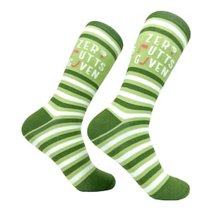 May include: A pair of green and white striped socks with the text "Zero Putts Given" in white letters. The socks have a golf flag and golf ball graphic.
