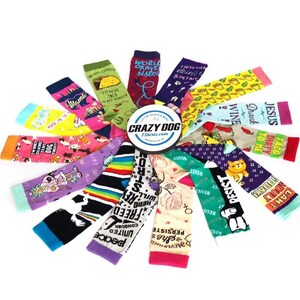 May include: A collection of colorful socks with various humorous and inspirational phrases printed on them. The socks are arranged in a circle with the Crazy Dog Tshirts.com logo in the center.