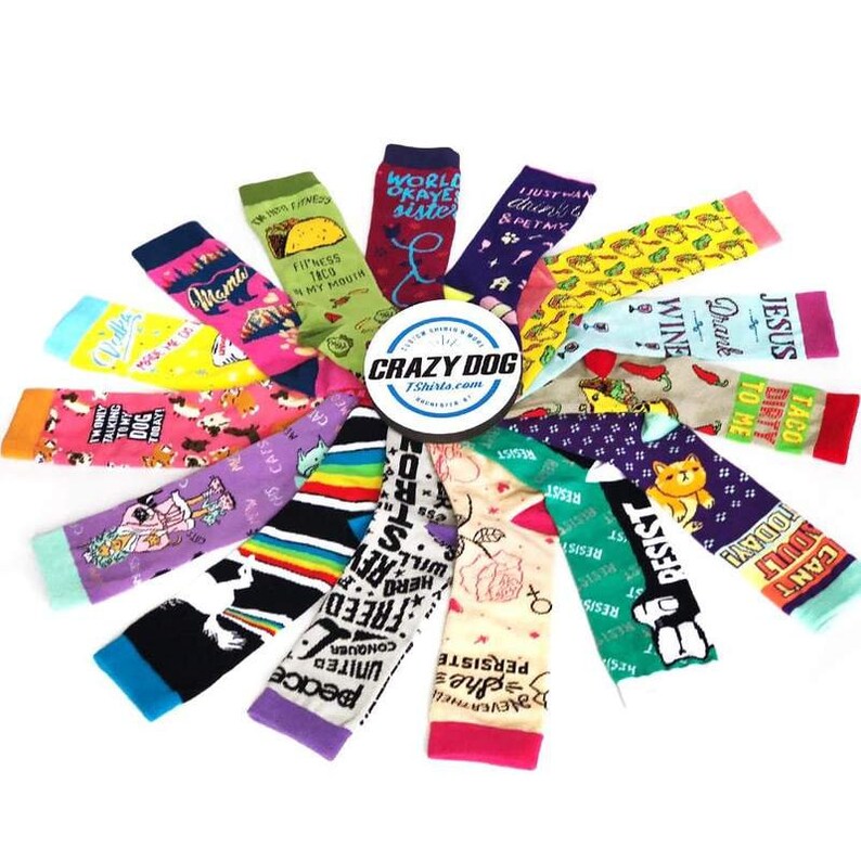 May include: A collection of colorful socks with various humorous and inspirational phrases printed on them. The socks are arranged in a circle with the Crazy Dog Tshirts.com logo in the center.