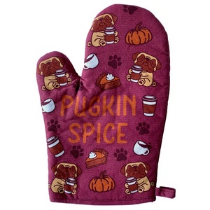May include: Burgundy red oven mitt with a pattern of pugs, pumpkins, and coffee cups. The text "Pugkin Spice" is printed in orange on the mitt.