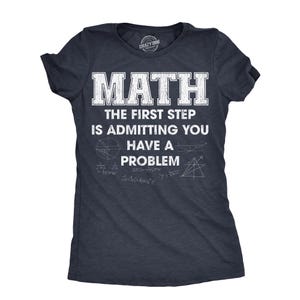 May include: Dark navy blue t-shirt with the text "MATH THE FIRST STEP IS ADMITTING YOU HAVE A PROBLEM" in white block letters. The shirt also features math symbols and equations. A Crazy Dog brand shirt.