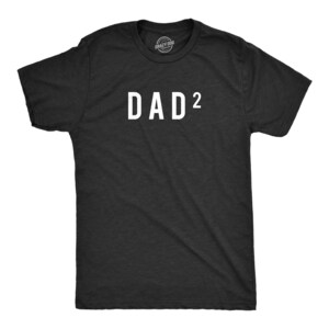 May include: A charcoal gray short-sleeve t-shirt featuring the white text DAD squared on the chest. The shirt has a crew neckline and a standard fit. The fabric has a heathered texture throughout, and a small brand logo is printed inside the neck.