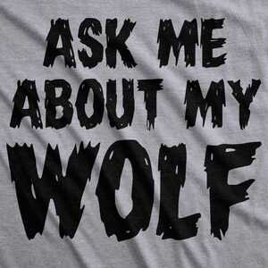 May include: Gray t-shirt with black text that reads "Ask me about my wolf".