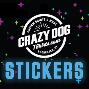 May include: Black background with colorful star shapes and the text "STICKERS" in light blue. A white circular logo in the center reads "CRAZY DOG TShirts.com ROCHESTER, NY" with the words "CUSTOM SHIRTS & MORE" around the top.