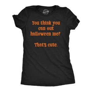 May include: Black t-shirt with orange text that reads "You think you can out halloween me? That's cute." The shirt has short sleeves and a crew neck. The Crazy Dog brand logo is visible at the top.