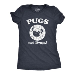 May include: A navy blue t-shirt with a white distressed graphic of a pug dog in a circle with the text "PUGS not Drugs!"