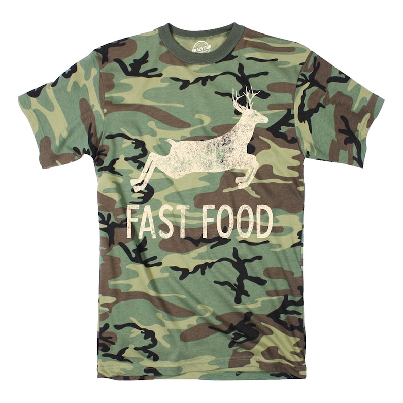 May include: A camouflage green t-shirt with a white silhouette of a deer jumping and the text "FAST FOOD" printed on the front.