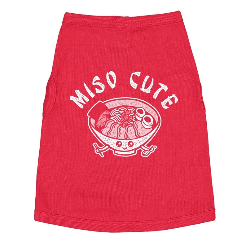 May include: Red sleeveless dog shirt with a white graphic of a bowl of ramen noodles with the text "Miso Cute" above it.