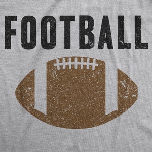 May include: A gray t-shirt with the word "FOOTBALL" printed in black and a brown distressed football graphic.
