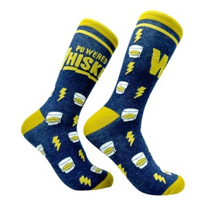 May include: A pair of blue socks with a yellow lightning bolt and whiskey glass pattern. One sock reads "Powered Whiskey".