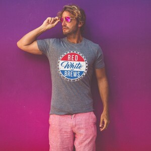 May include: A gray t-shirt with a red, white, and blue graphic of a bottle cap that says "Red White & Brews".