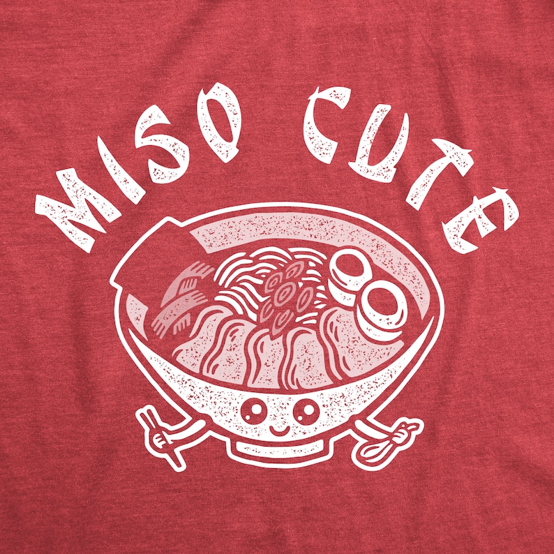 May include: Red t-shirt with white text that says "Miso Cute" and a cartoon illustration of a bowl of ramen with a smiling face.
