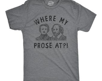 May include: A heather gray short-sleeve t-shirt featuring a black graphic print of Edgar Allan Poe and William Shakespeare. The text "WHERE MY PROSE AT?!" is printed in black above and below the portraits of the two historical literary figures.
