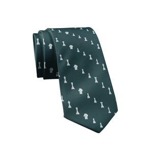 May include: A dark teal necktie featuring a repeating pattern of small white chess piece silhouettes, including kings, queens, knights, and pawns arranged in diagonal lines across the fabric surface of the folded necktie accessory.