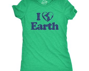 May include: A bright green short-sleeved t-shirt featuring a dark blue graphic print on the chest. The design displays the letter I, a heart-shaped globe icon, and the word Earth in a distressed font. The shirt has a crew neckline and a heathered texture.