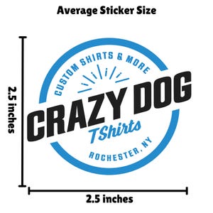 The image is a logo for a company called "Crazy Dog Tshirts" that specializes in custom shirts and more. The logo is designed in a blue and white color scheme and measures 2.5 inches in diameter.